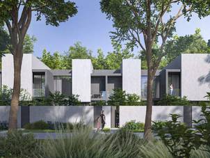 Townhouses in Masaar, set within a lush green environment, showcasing Arada's focus on blending modern living with nature.