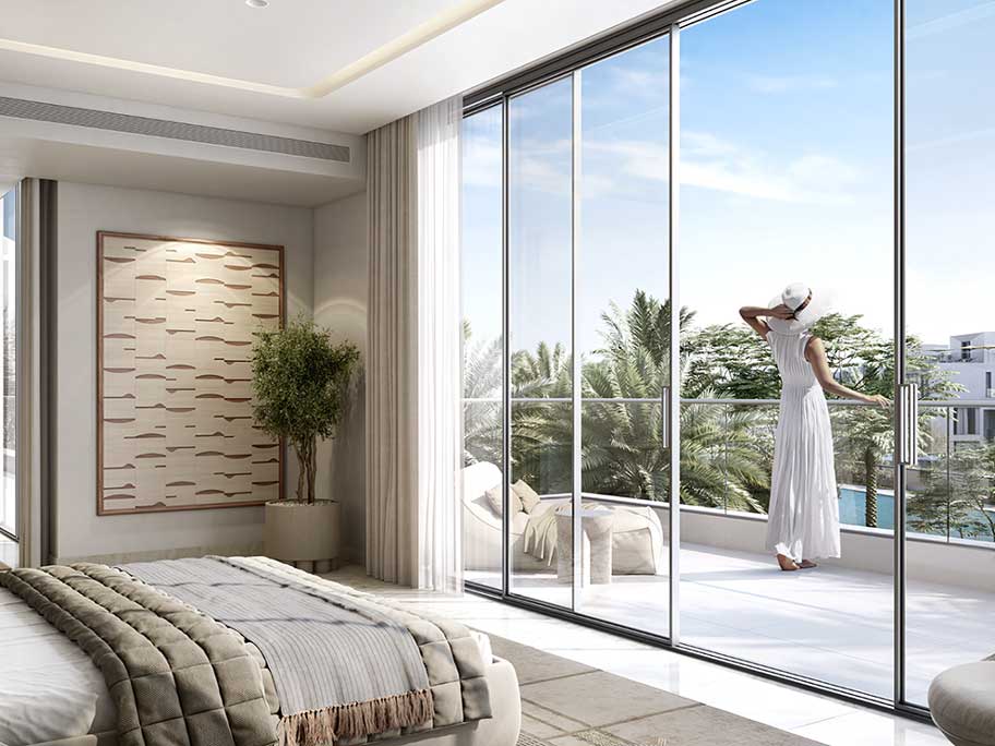 Luxury bedroom at Oasis by Emaar in Dubai with a spacious balcony, modern decor, and scenic views of palm trees and a serene landscape