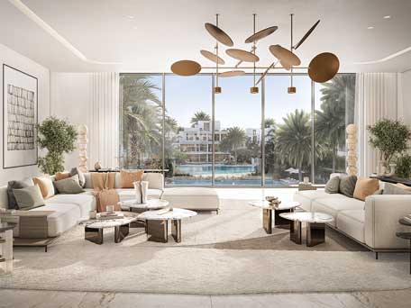 A spacious and luxurious living room with large windows overlooking a pool and greenery at The Oasis by Emaar