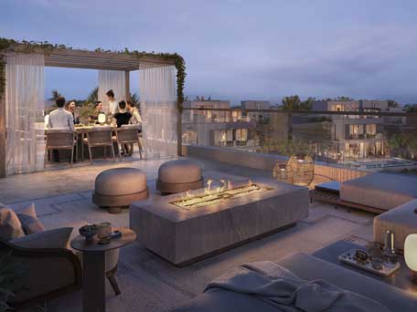 Rendering of a luxurious outdoor terrace at Oasis by Emaar, with a dining area, lounge seating, and a fire pit.