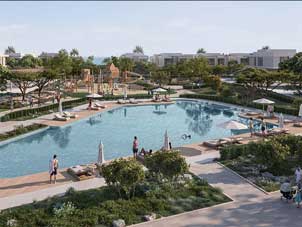 Aerial view of the Ora Bayn residential community featuring a large swimming pool, playground, and lush landscaping.