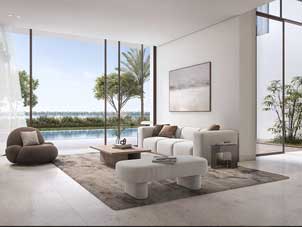 A bright and contemporary living room in a Ora BAyn apartment with expansive windows offering an outdoor view that includes water and greenery.