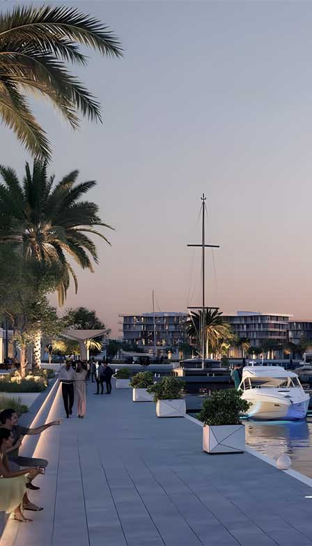 Sunset view of Ora Bayn marina in Ghantoot with yachts, palm trees, and modern buildings.