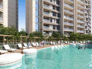 Scenic view from an apartment balcony at Ghaf Woods, showcasing the modern architecture and landscaped environment.