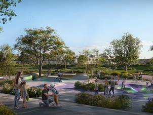 Kids' playground at Riviera in The Valley by Emaar, a residential development in Dubai, featuring colorful play structures and green surroundings.