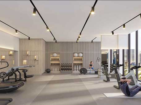 Modern gym at Urban Park Residences with advanced equipment, large windows, and city views